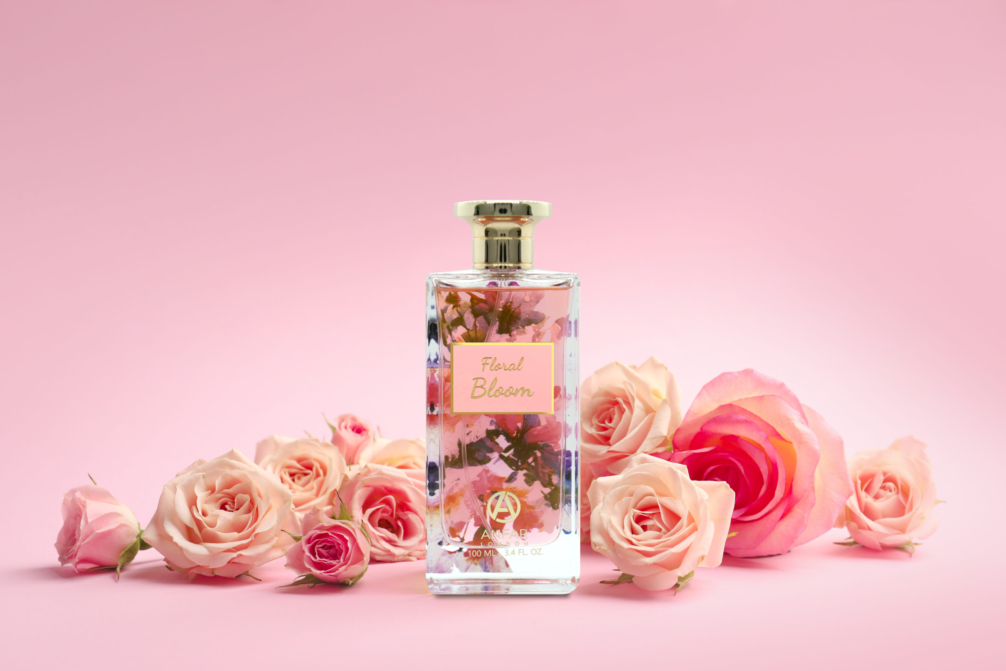 Bottle of perfume with flowers on color background